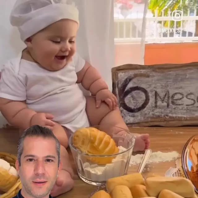 Mutfakta annesinin yemek hazırlamasını mama sandalyesinden izleyen mutlu bir bebek